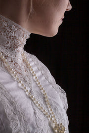 Edwardian woman in a white lace blouse and skirt with a pearl necklace (Tayla 0024)